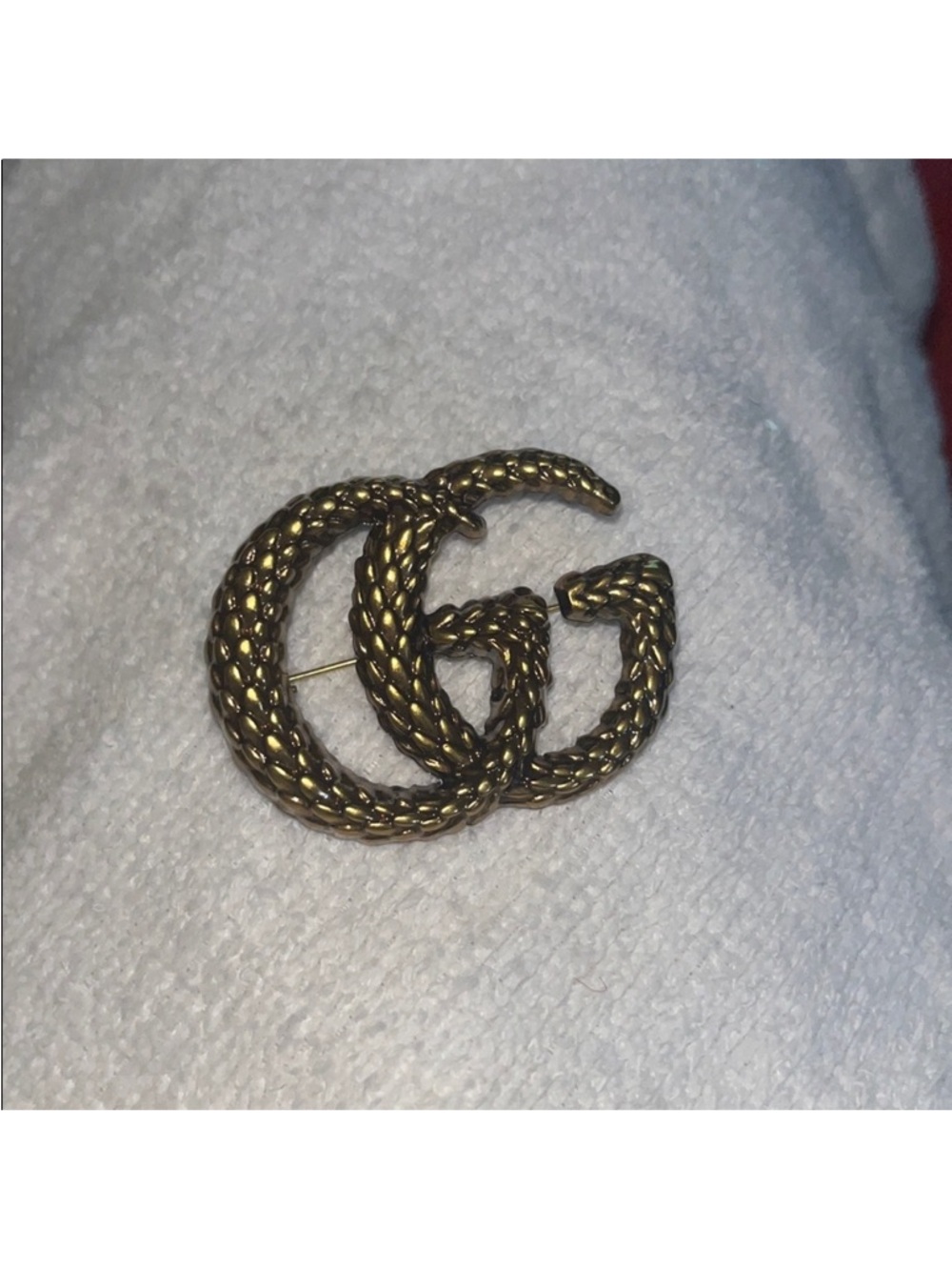 GG Interlocking Logo Brooch in Aged Gold
